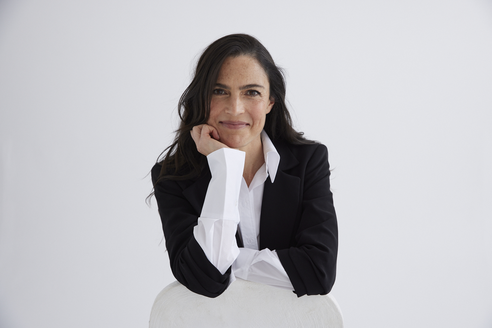 Jayne Halikiotis, Occupational Therapist and Founder of Hali Institute, seated in a black blazer with warm, direct eye contact